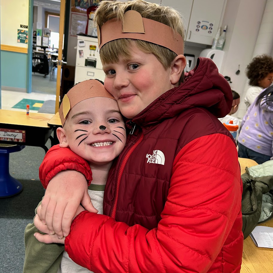 Two students dressed as chipmunks hug. 